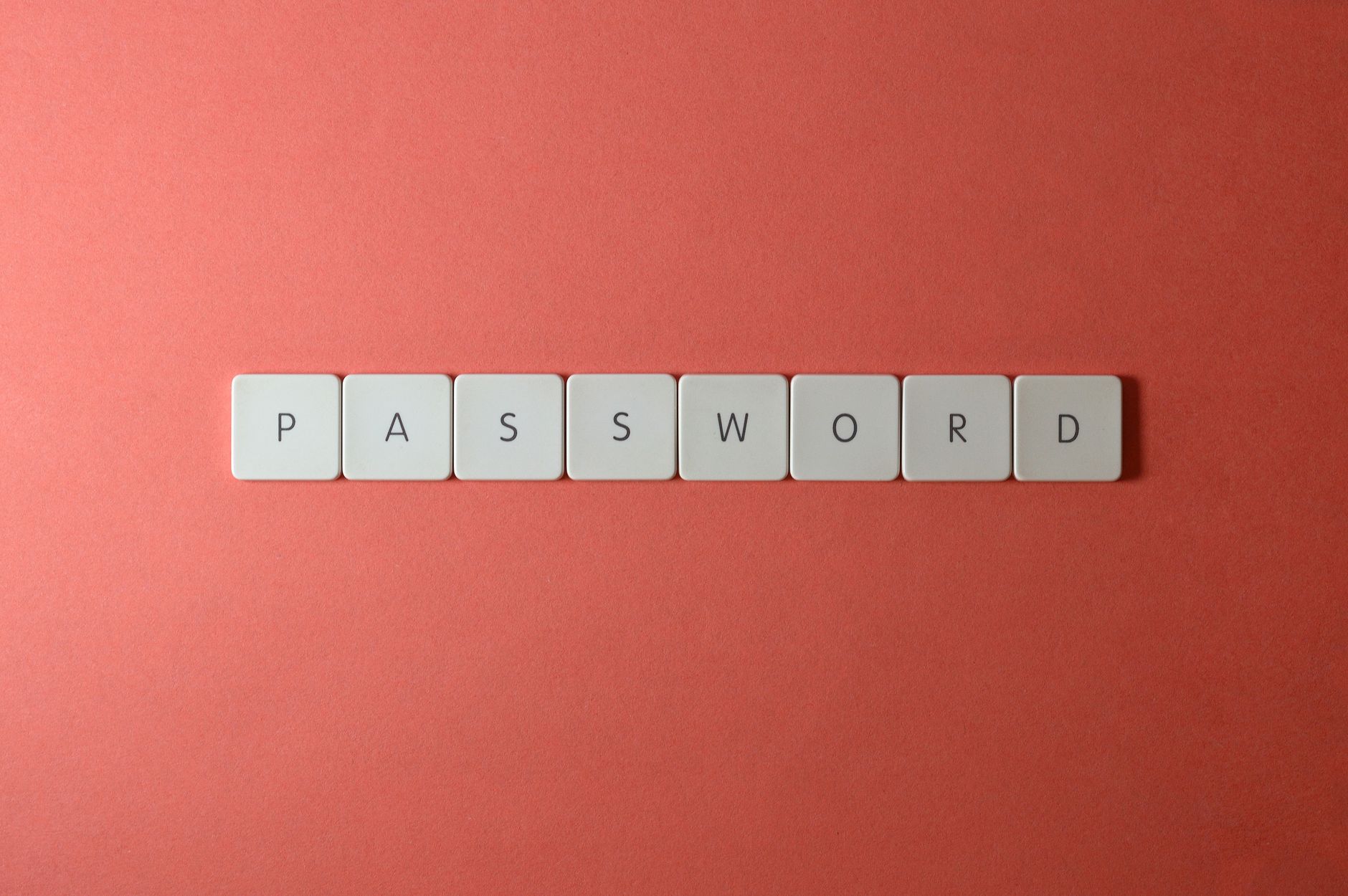 Białe kafelki z napisem PASSWORD na koralowym tle Białe kafelki z napisem PASSWORD na koralowym tle